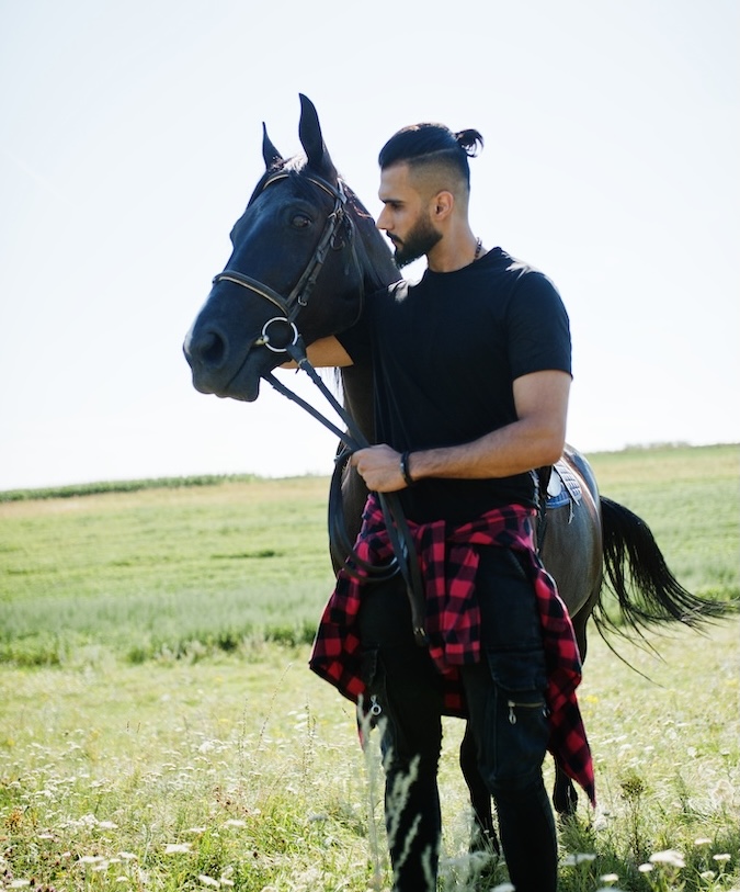 Tall man with black horse.