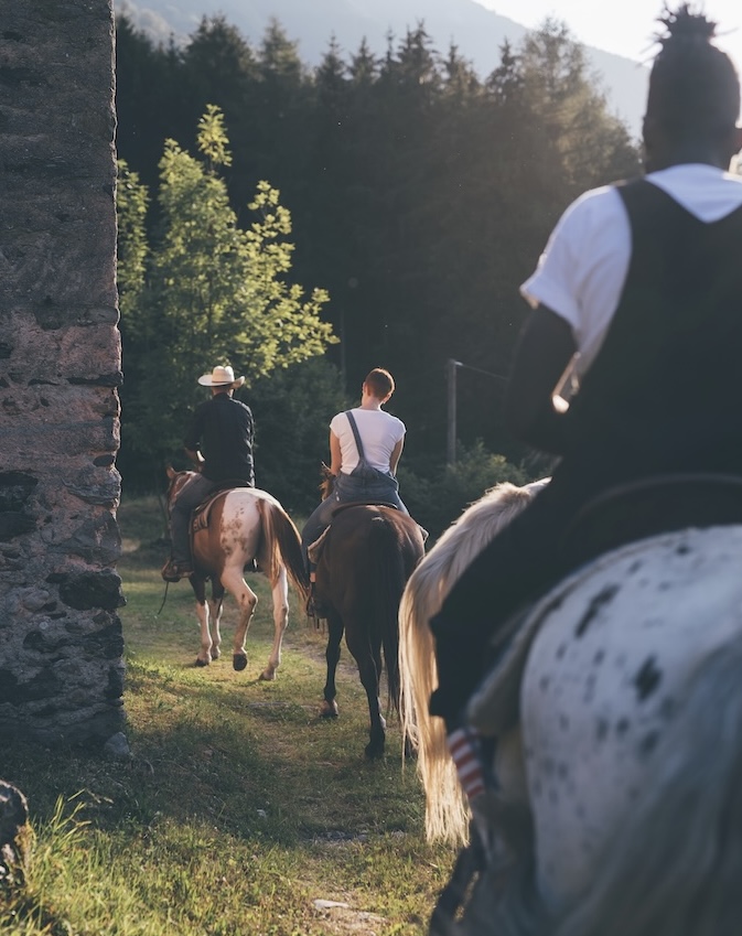 Young adults riding on rural track