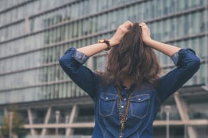 woman with hair covering face defense mechanisms and addiction