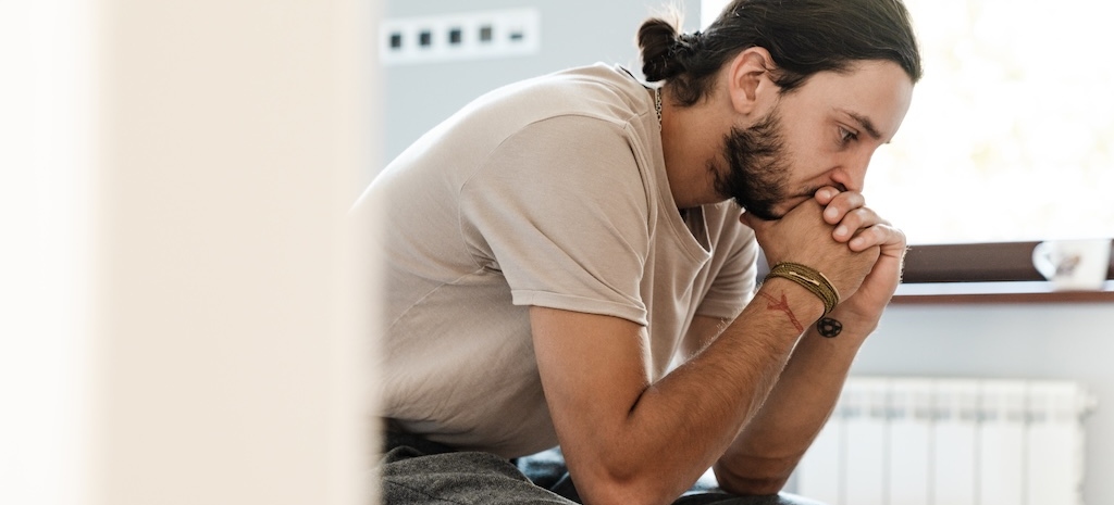 Young man experiencing depression after drug comedown.