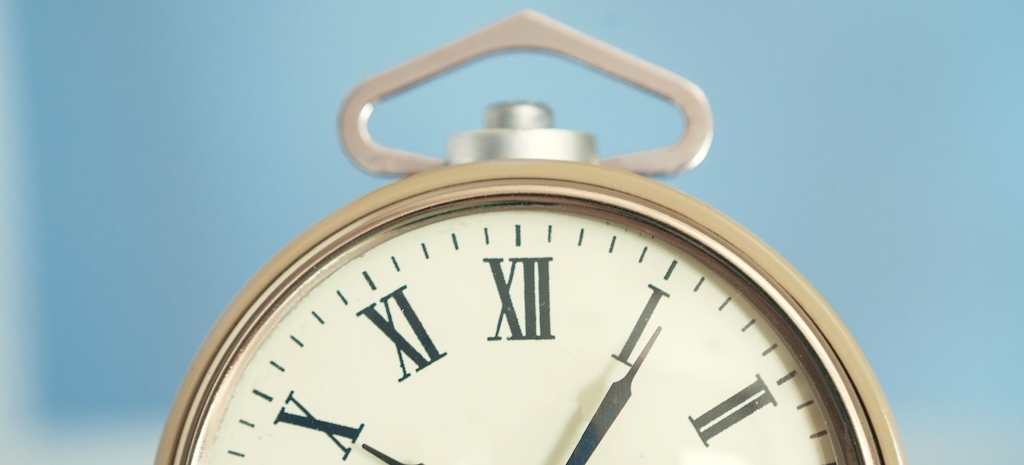 Close up of vintage alarm clock on wooden table